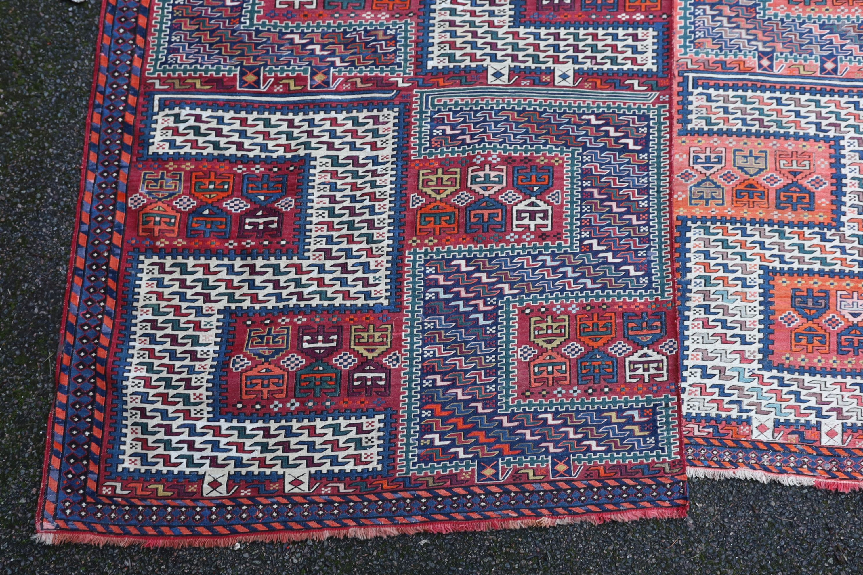 A Sumak weave 2-sectional carpet, combined dimension - 320 x 230cm.